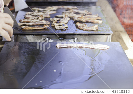 Roasting bacon on the grill Roasting bacon on the grill 45210313