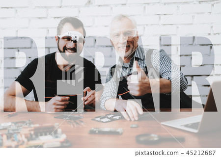Happy Men Testing Laptop Components Fixing Gadget. Happy Men Testing Laptop Components Fixing Gadget. 45212687
