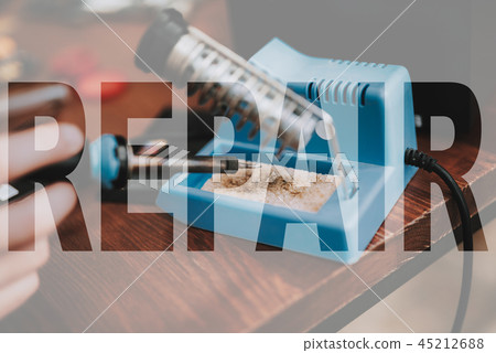 Hands with Small Soldering Iron Smartphone Repair. 45212688