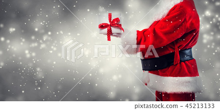 Santa holding a Christmas gift Santa holding a Christmas gift 45213133