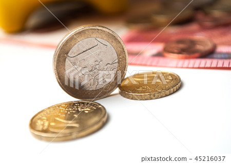 yellow piggy bank on euro coins and bank notes yellow piggy bank on euro coins and bank notes 45216037