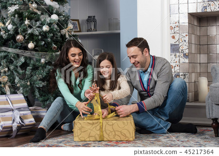 Family gather near Christmas tree Family gather near Christmas tree 45217364