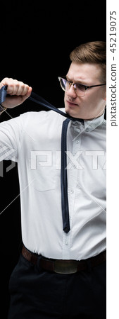 Portrait of confident handsome fed up tired elegant responsible businessman on black background Portrait of confident handsome fed up tired elegant responsible businessman on black background 45219075