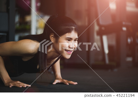 Asian young woman doing push-ups at the gym 45221194