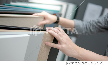 Male hand choosing cabinet or countertop materials Male hand choosing cabinet or countertop materials 45221260