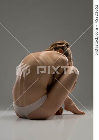 Sexy girl topless on the floor rearview Sexy girl topless on the floor rearview 45223052