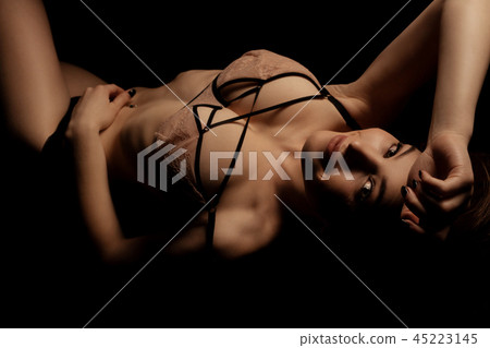 Young girl in sexy bra on the sofa in the dark 45223145