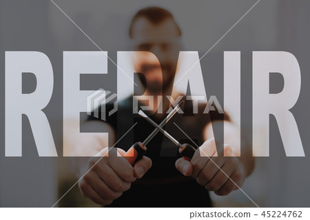 Happy Technician in Workwear Hold Screwdrivers. 45224762