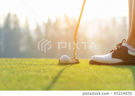 Hand asian woman putting golf ball on tee with clu 45224870