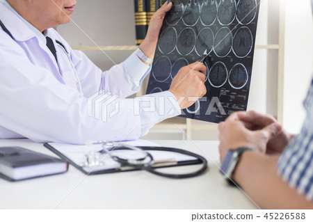 doctor analyzing a scan or x-ray film or explains a CT scan thou doctor analyzing a scan or x-ray film or explains a CT scan thou 45226588