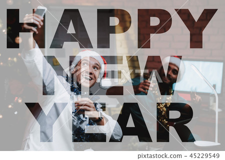 Two Doctors Celebrating New Year's Eve In Office. 45229549