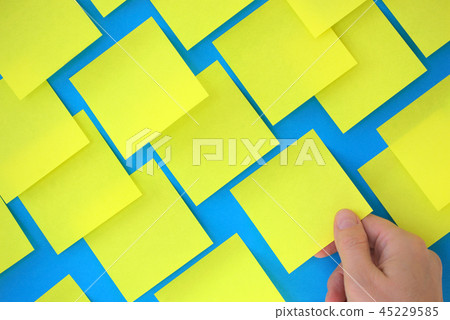 Hand holding post-it note Hand holding post-it note 45229585