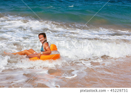 Happy girl have fun in sea surf on beach 45229731