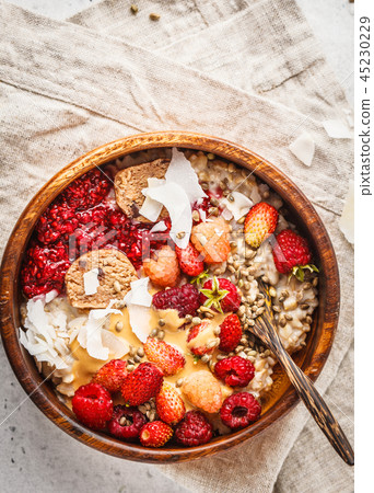 Trendy vegan bowl of oatmeal porridge with berries Trendy vegan bowl of oatmeal porridge with berries 45230229