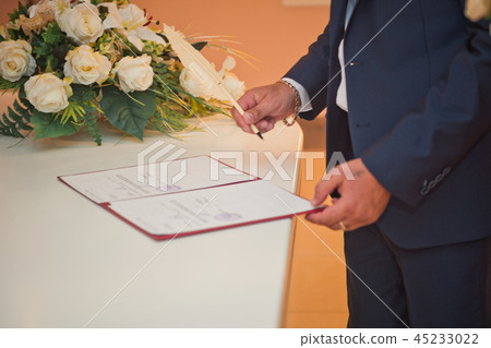 A man signs a document with a pen 1781. A man signs a document with a pen 1781. 45233022