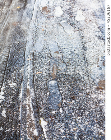 frozen footprints on surface of ice-crusted road frozen footprints on surface of ice-crusted road 45236167