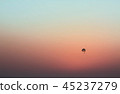 The parachute flies across the sky 45237279