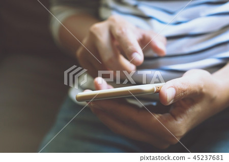 Young business man plaid shirt using on cell phone Young business man plaid shirt using on cell phone 45237681