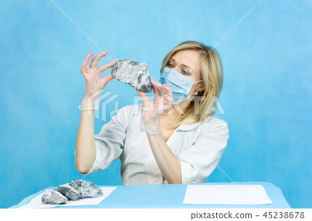 girl laboratory examines samples minerals. girl laboratory examines samples minerals. 45238678