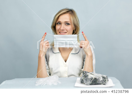 The girl lab technician puts on a mask. 45238796
