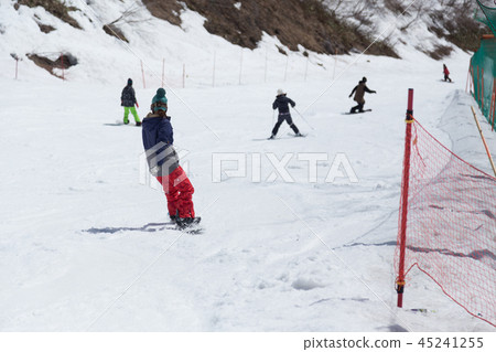 A woman snowboarding 45241255