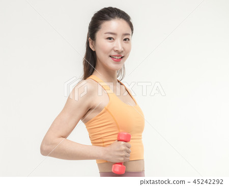 Korean woman exercising with dumbbells Korean woman exercising with dumbbells 45242292