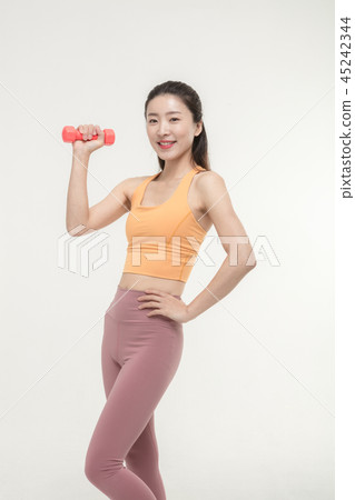 Korean woman exercising with dumbbells Korean woman exercising with dumbbells 45242344