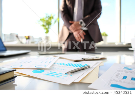 Silver pen lie at important paper on table in office 45243521