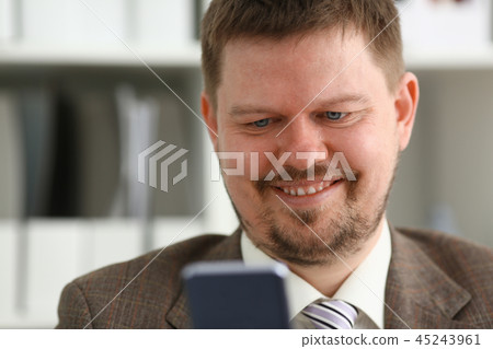 Handsome smiling businessman talk cellphone 45243961