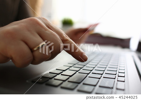 Male arms hold credit card press buttons making transfer Male arms hold credit card press buttons making transfer 45244025