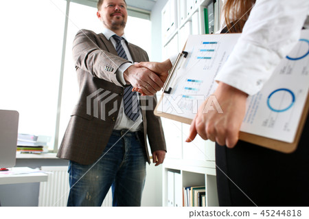 Man in suit and tie give hand as hello in office 45244818