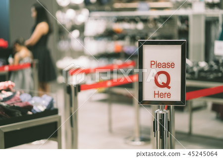 Red sign board with text please queue here Red sign board with text please queue here 45245064