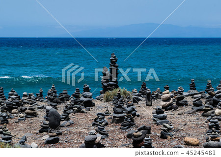 Cairn rock pebbles on Tenerife beach, Costa Adej Cairn rock pebbles on Tenerife beach, Costa Adej 45245481