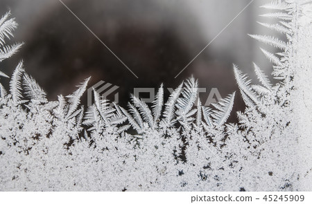Frost pattern on the window, cold winter Frost pattern on the window, cold winter 45245909