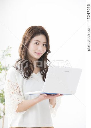 A woman looking at a computer A woman looking at a computer 45247956