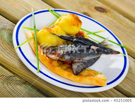 Dish of tasty fried sprats with fried potato croquettes and cake 45251005