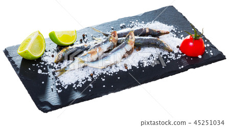 Deliciously dish of anchovy baked in the oven on a pillow of sea salt Deliciously dish of anchovy baked in the oven on a pillow of sea salt 45251034