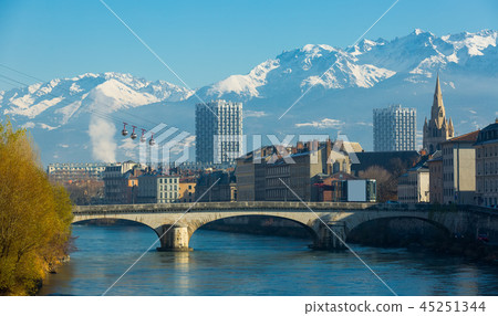 Grenoble with cable car against backdrop of snowy Alps 45251344