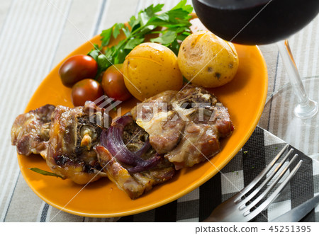 Baked lamb leg steaks with potatoes, tomatoes, parsley 45251395