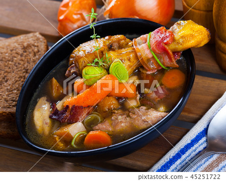 Cooked tasty soup of chicken, bacon and leek, served in bowl at table 45251722