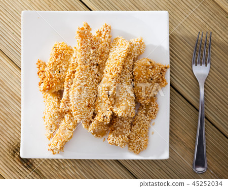 Top view of deep-fried chicken strips in sesame 45252034