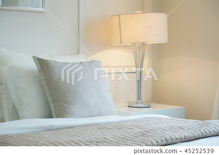 Beige color scheme bedding with white reading lamp 45252539