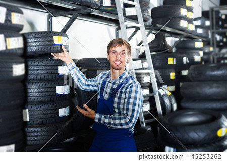 Man standing with auto tires 45253262