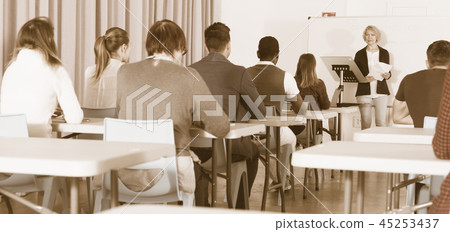 Students with teacher studying in classroom 45253437