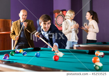 Group of friends playing billiards 45253525