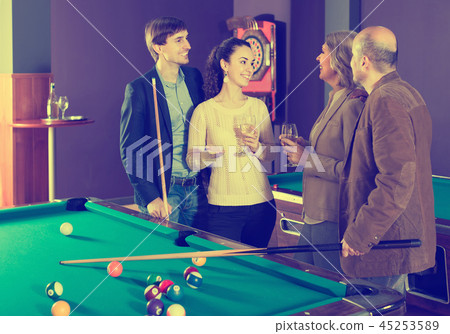 Mature and young couples hanging out in billiard club together 45253589