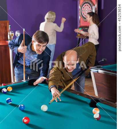 Relaxed people playing billiard and darts 45253654