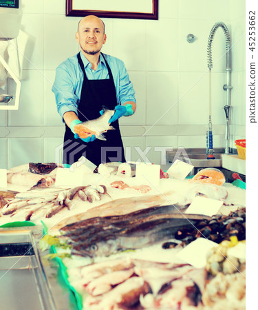 Smile man selling frozen good fish Smile man selling frozen good fish 45253662