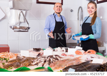 Two sellers in fish store . 45253717