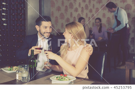 Young couple on romantic date drinking red wine Young couple on romantic date drinking red wine 45253795